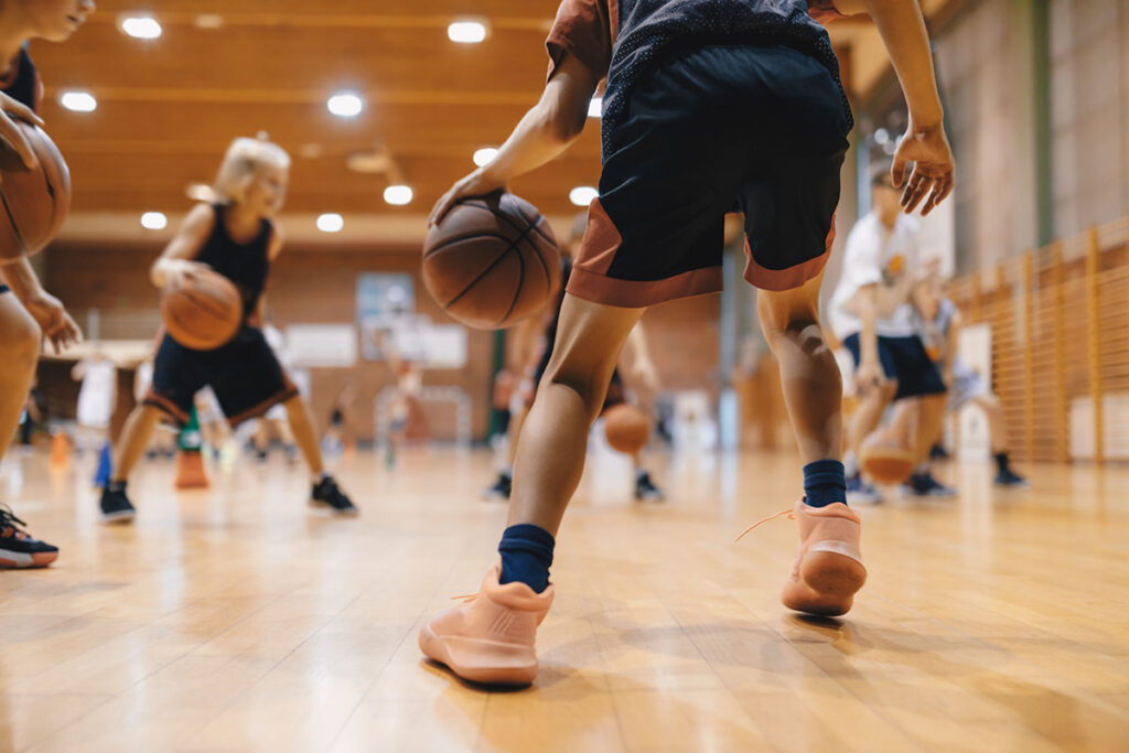 kids playing basketball in school gym